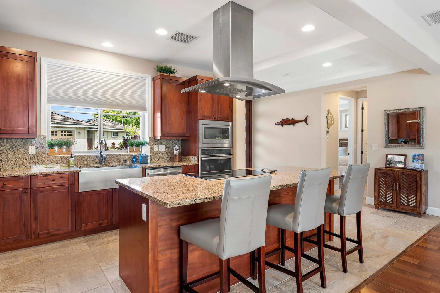 A spacious kitchen with a central island and bar seating.