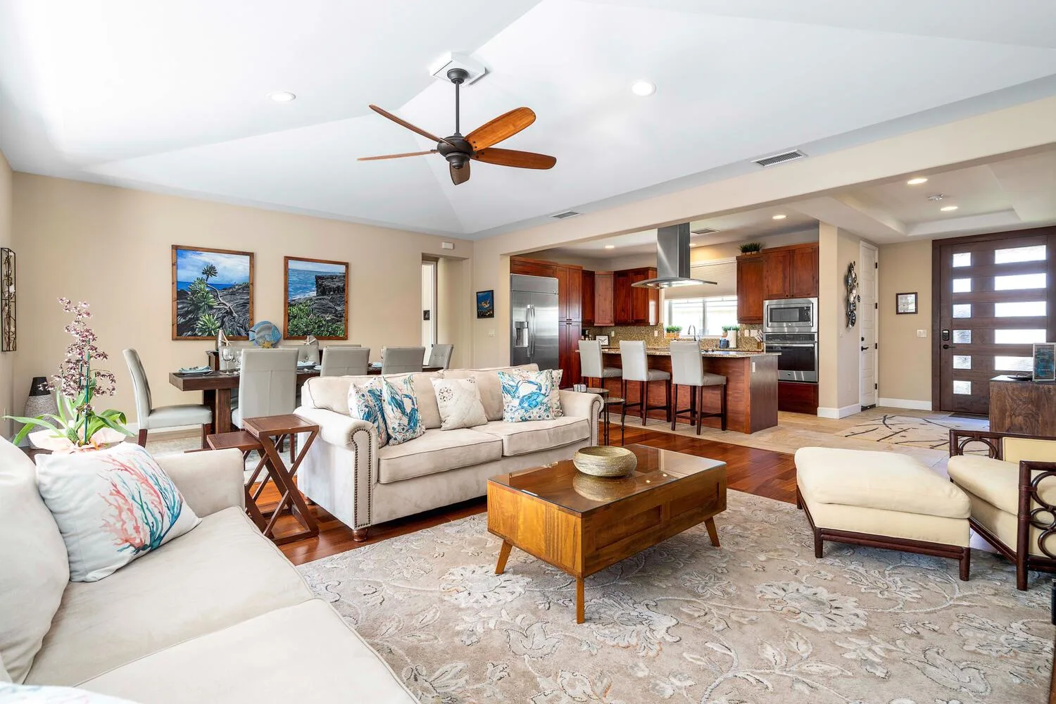 An open-plan living and dining area with seating and a kitchen.
