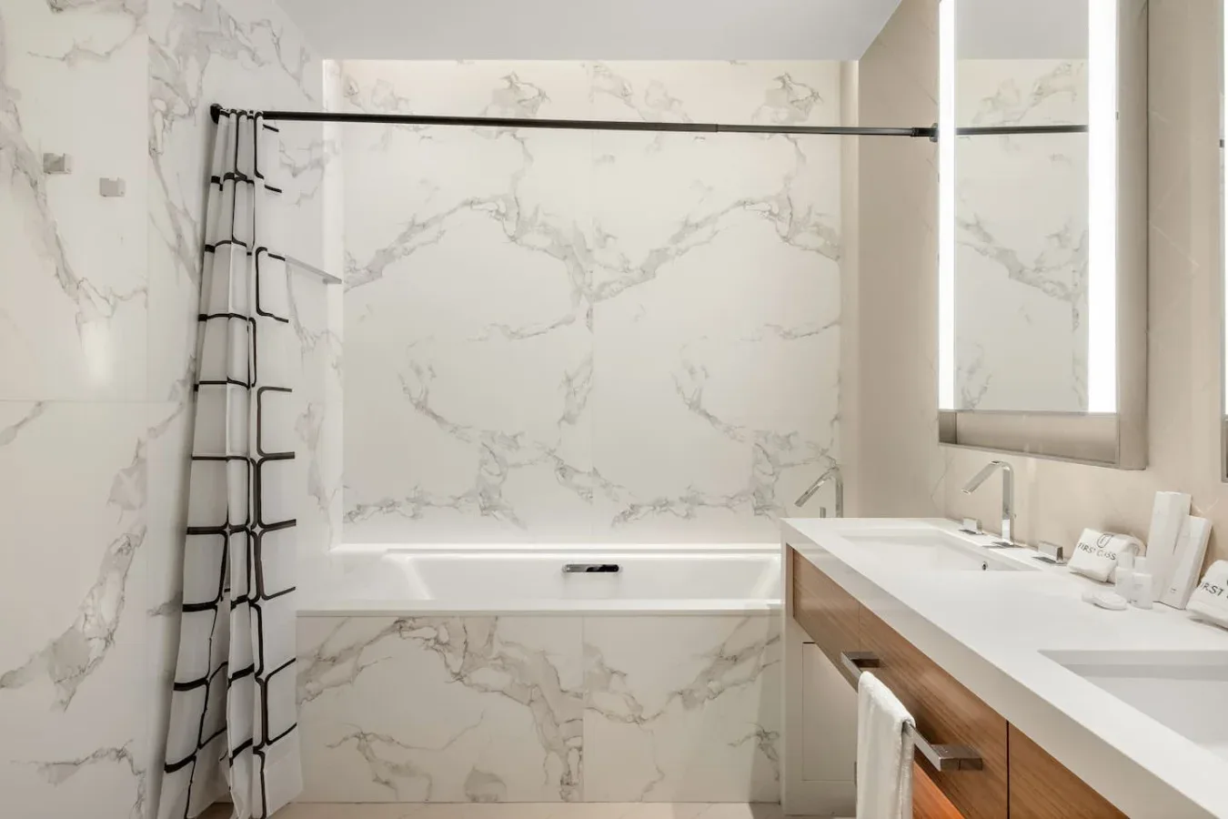 A bright bathroom with a bathtub and a long vanity.