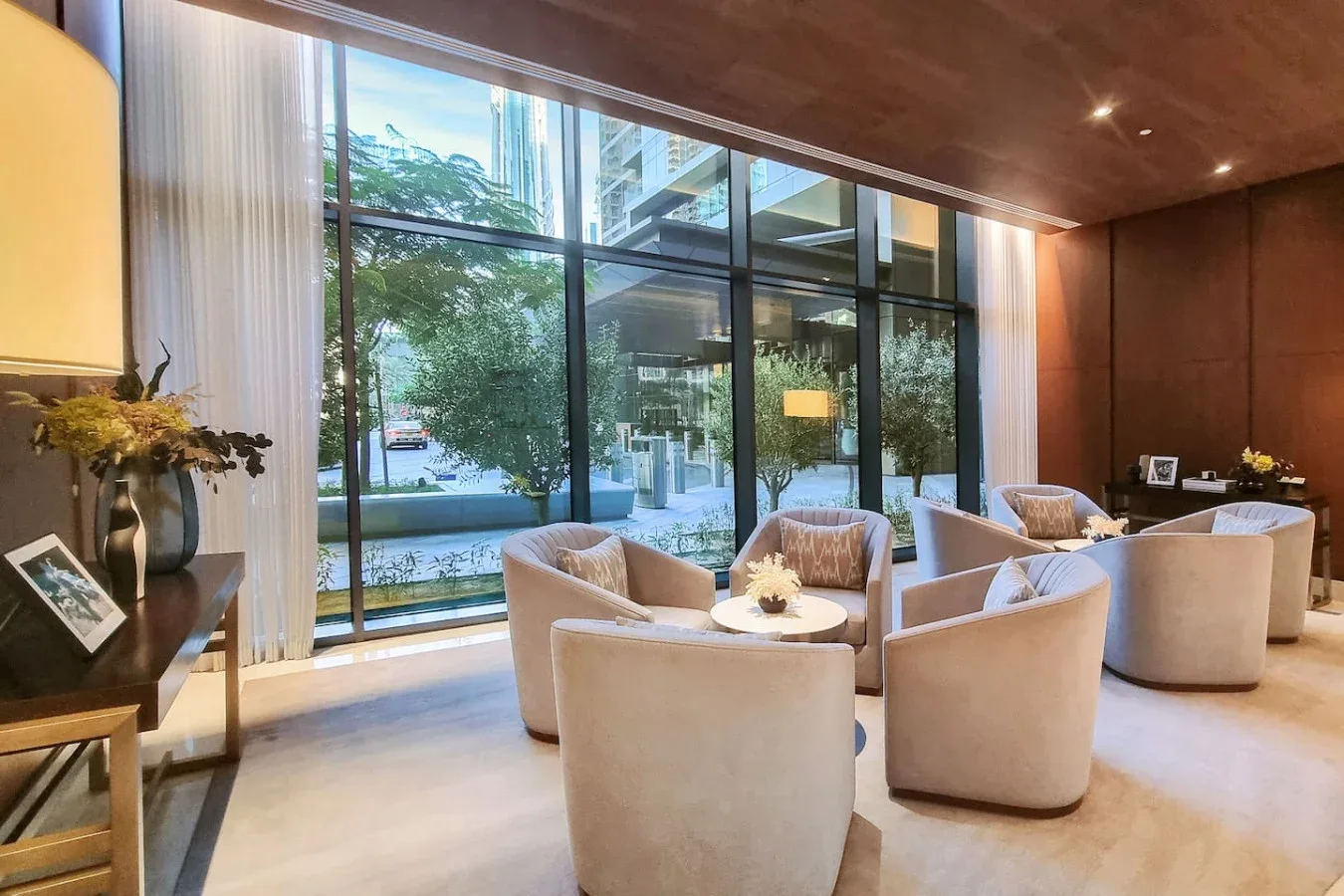 A bright lounge with curved seating arranged beside large windows.