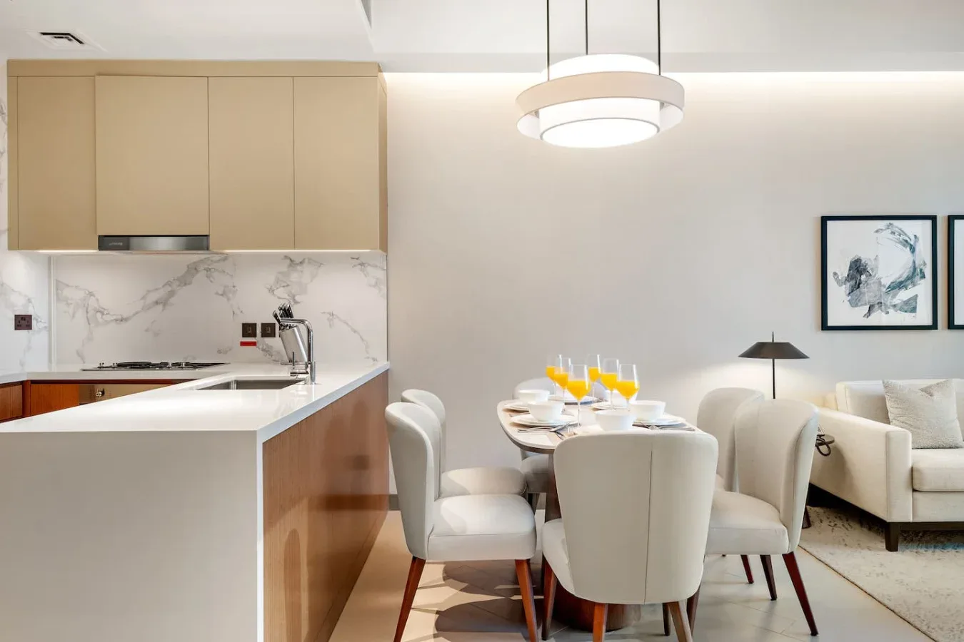 An open-plan kitchen and dining area with a table set beside the kitchen counter.