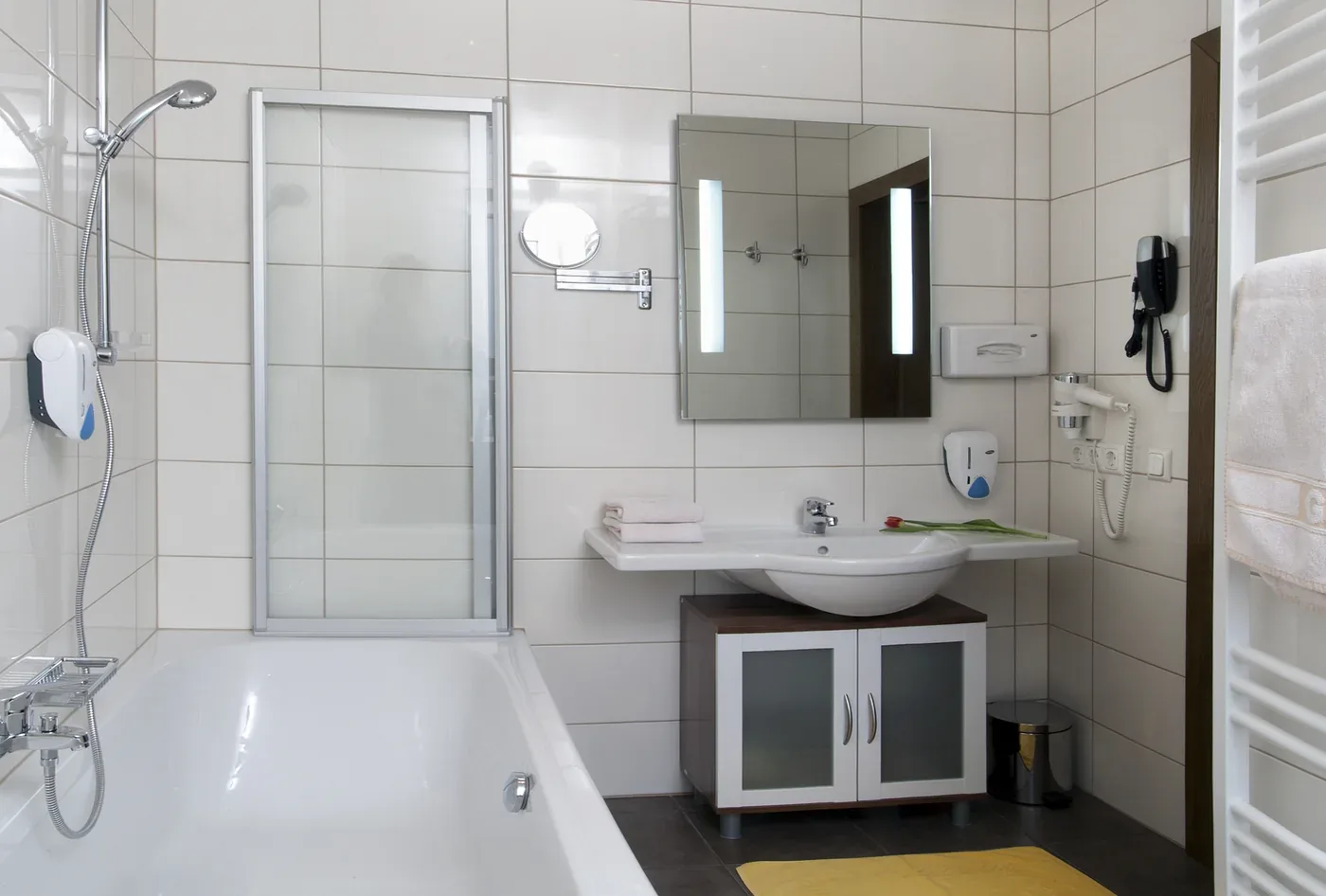 Bathroom in Suite 112 with combined shower and bathtub