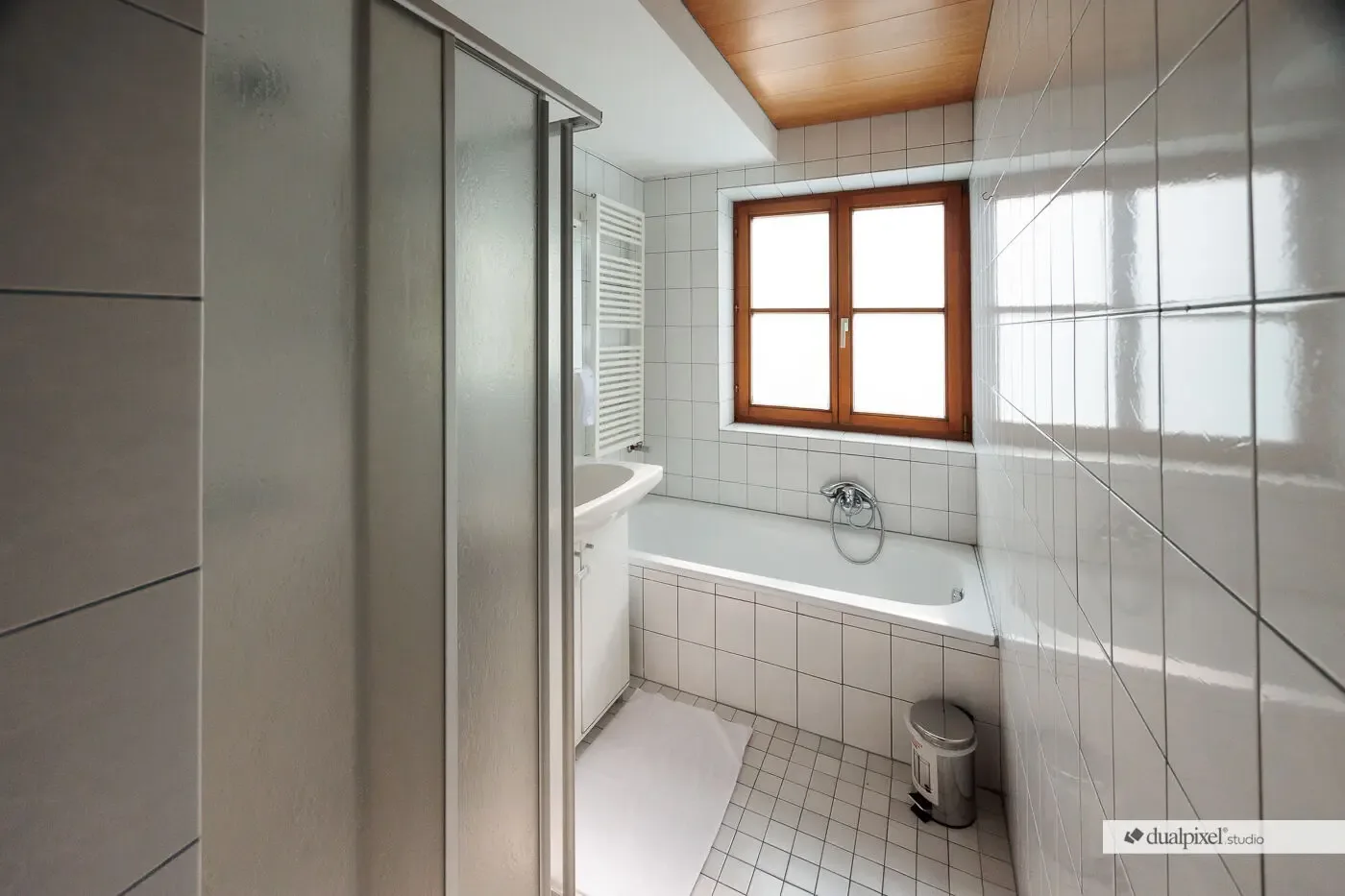 Holiday-house bathroom with bathtub and shower