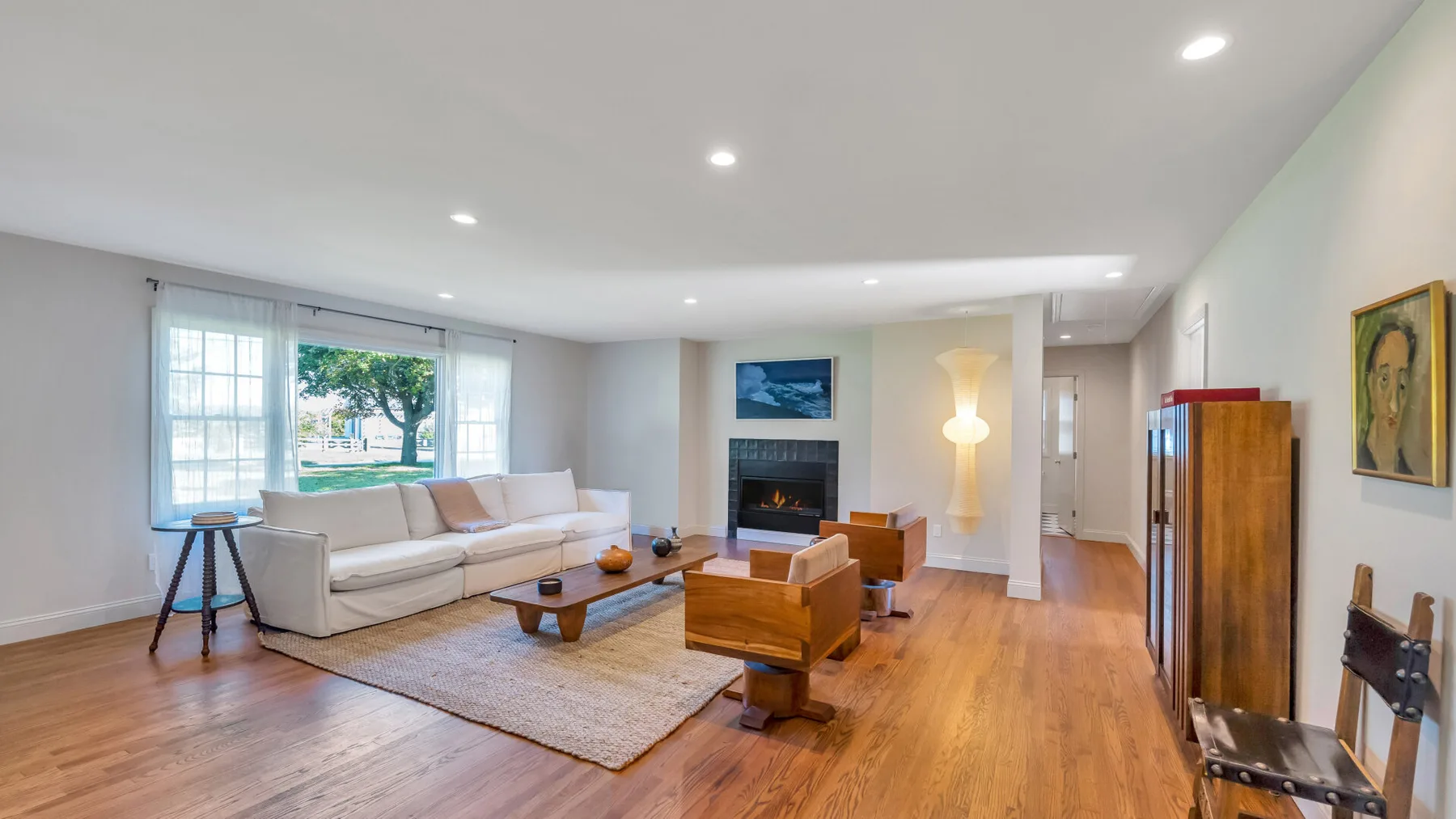 A bright living room with seating arranged around a coffee table.