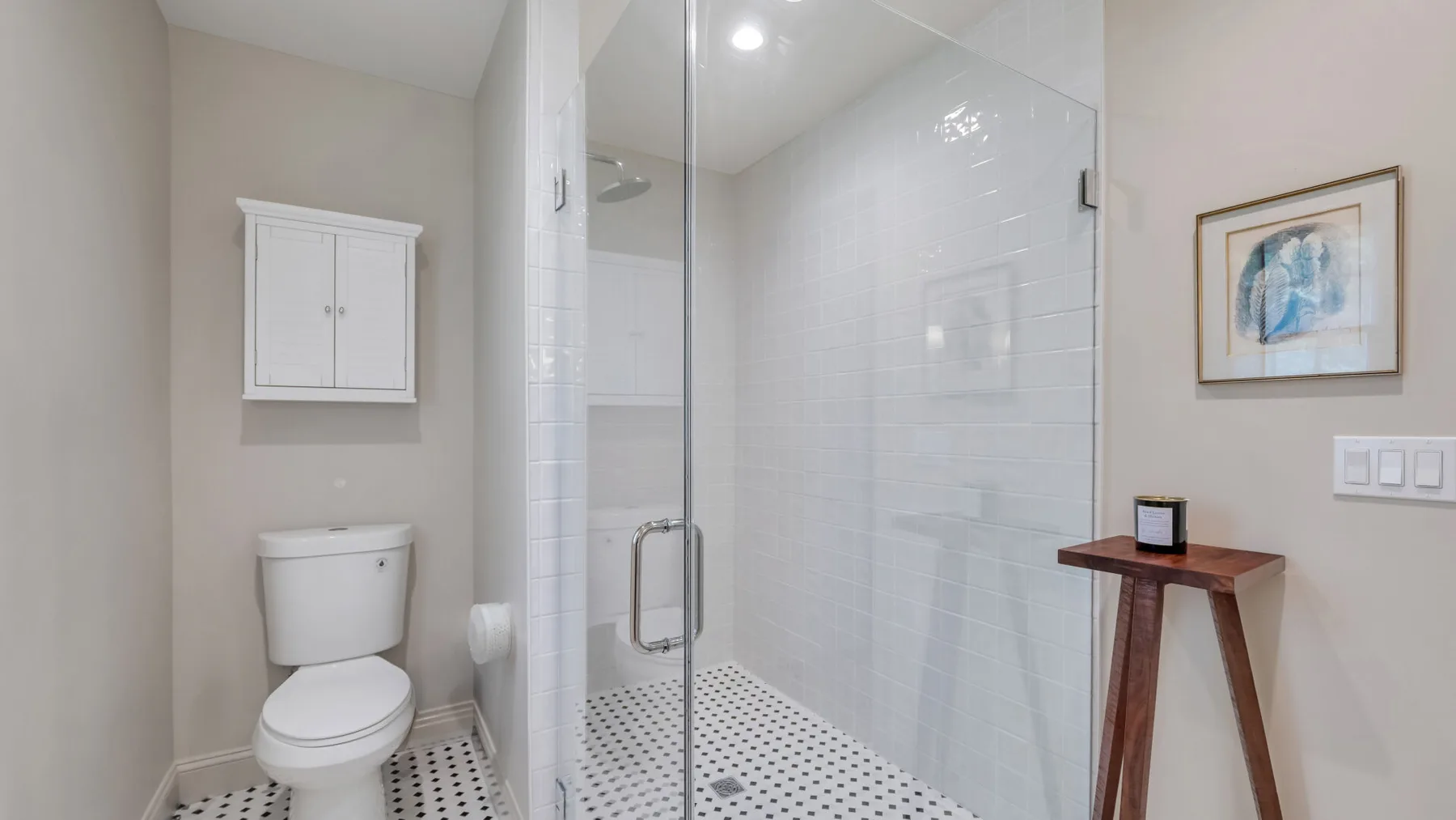 A bathroom with a glass shower and toilet.