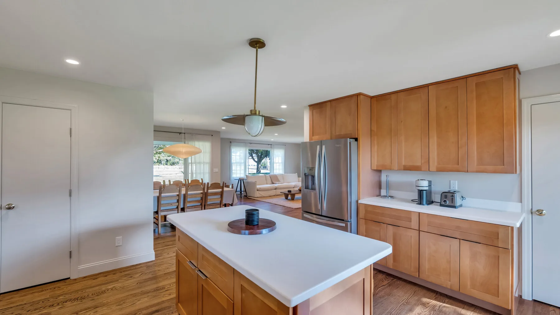 A bright kitchen with a large island and wooden cabinets.