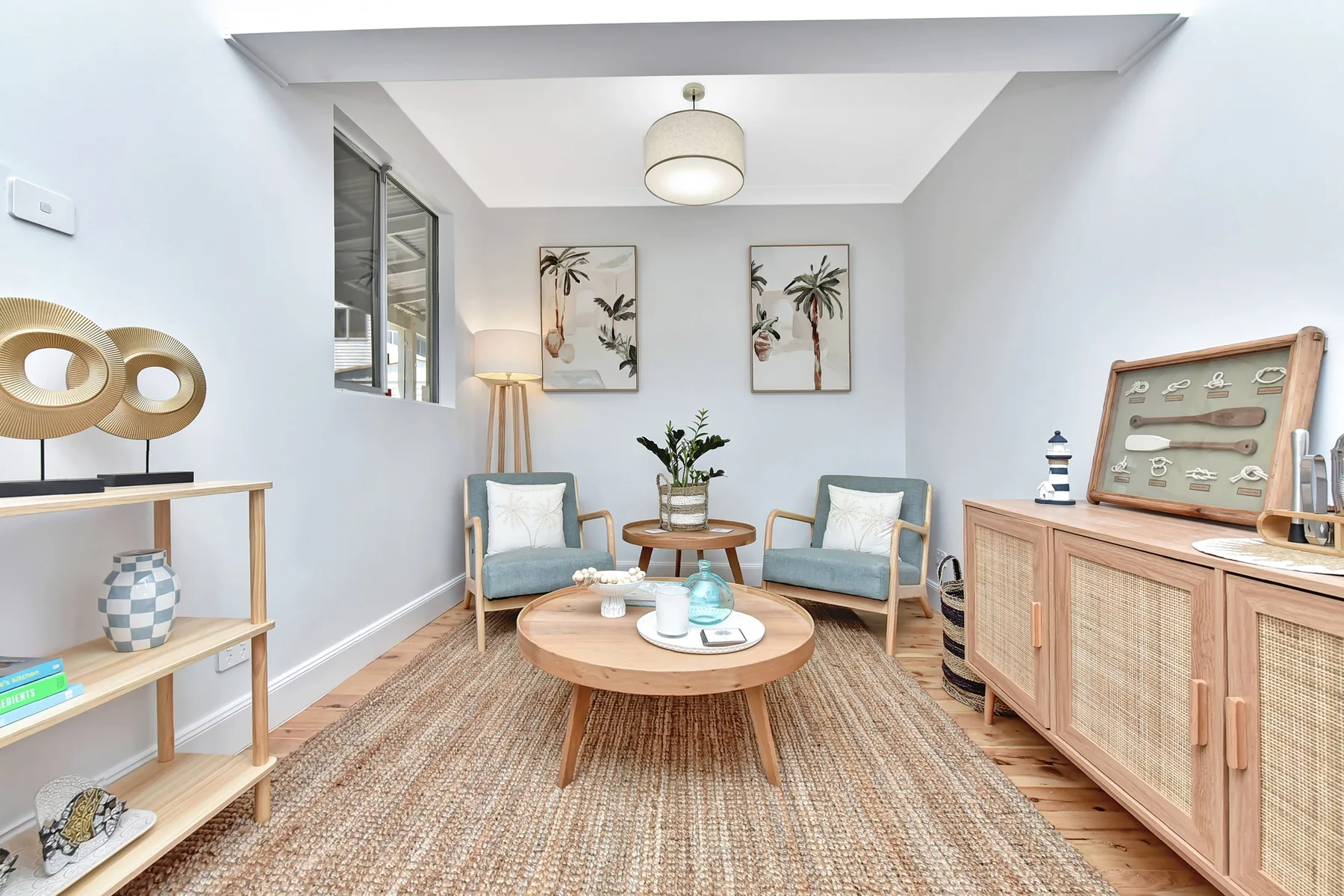 A bright living room with seating around a low wooden coffee table.