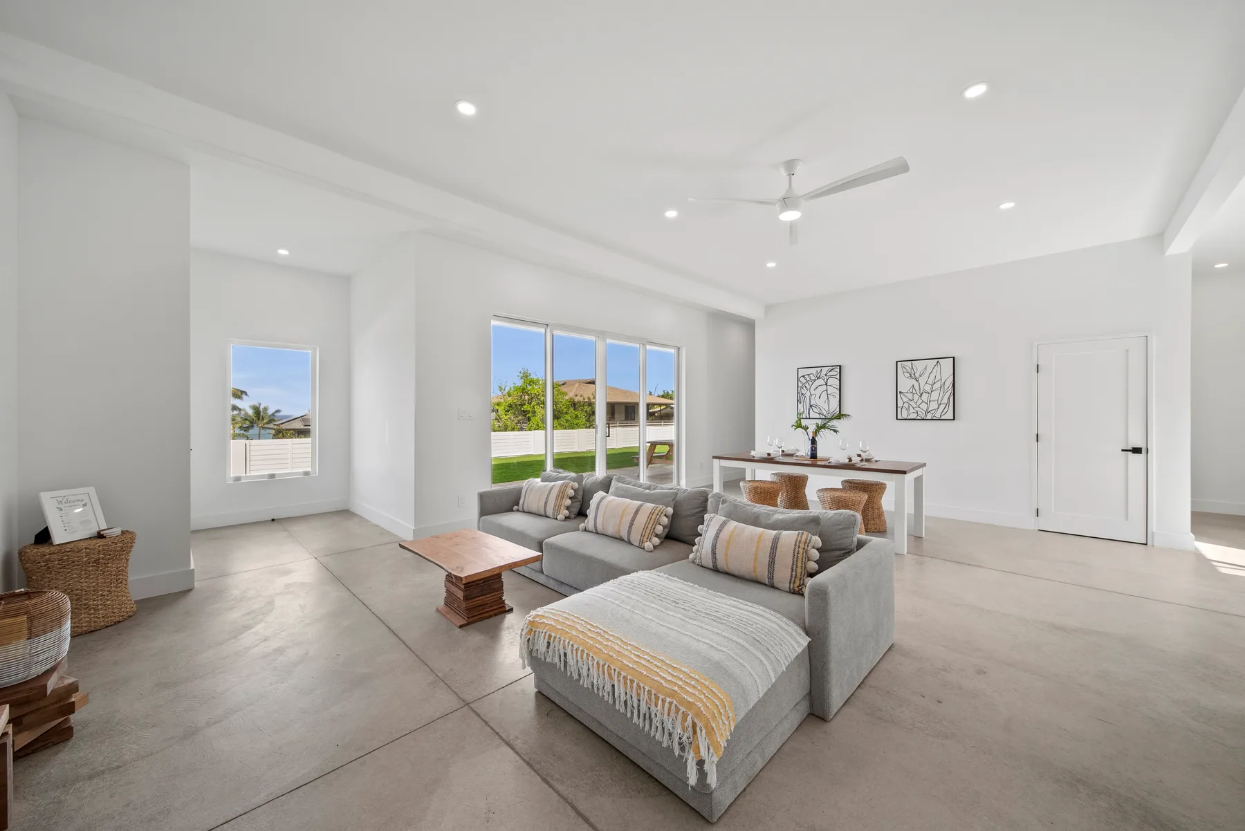 A bright living room with sectional seating and large windows.