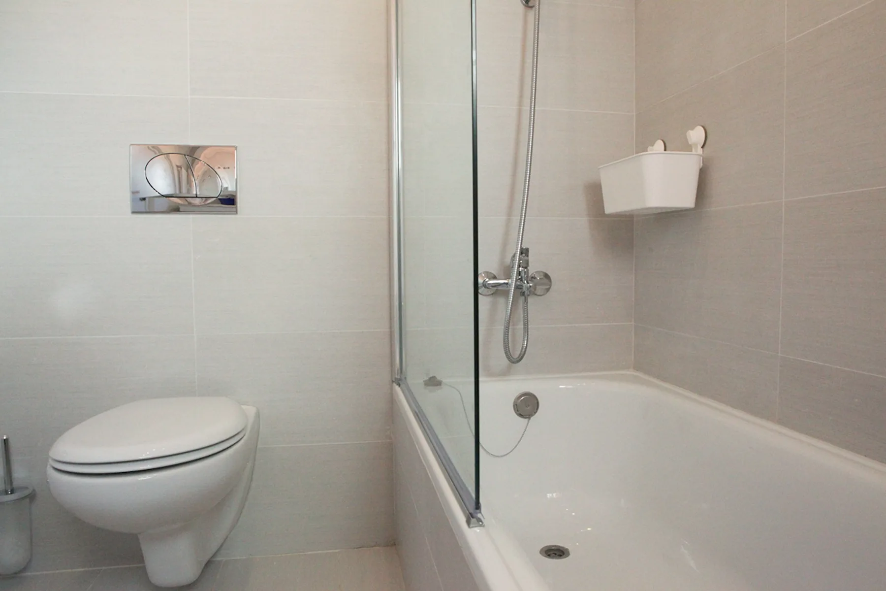 A tiled bathroom with a bathtub, shower, and toilet.