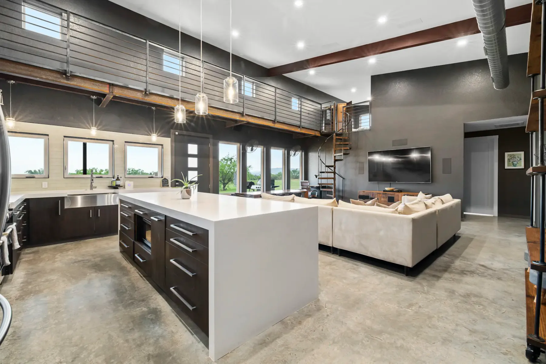 An open-plan living area and kitchen with a large island and seating.