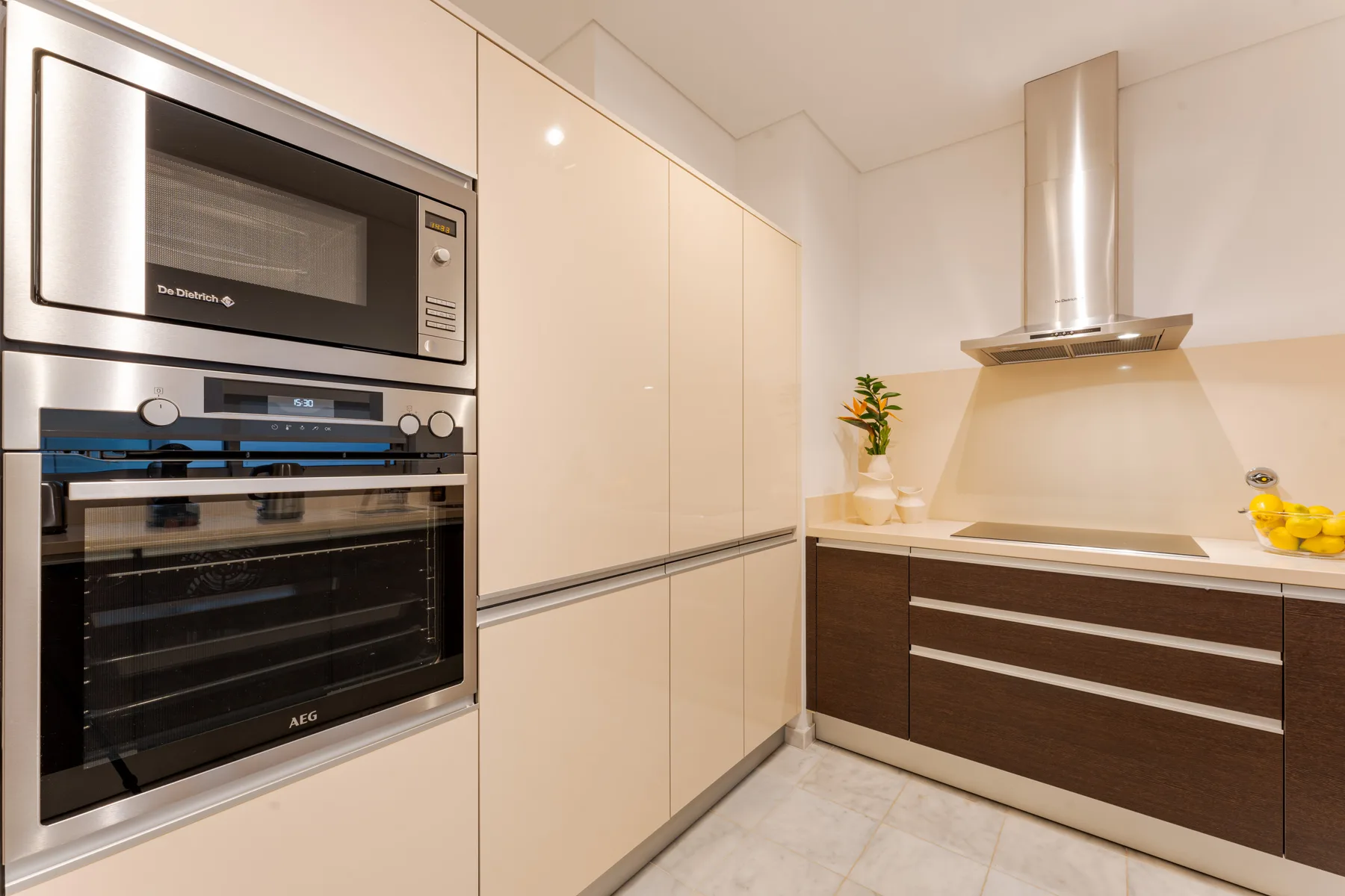 A modern kitchen with built-in appliances and light-colored cabinetry.