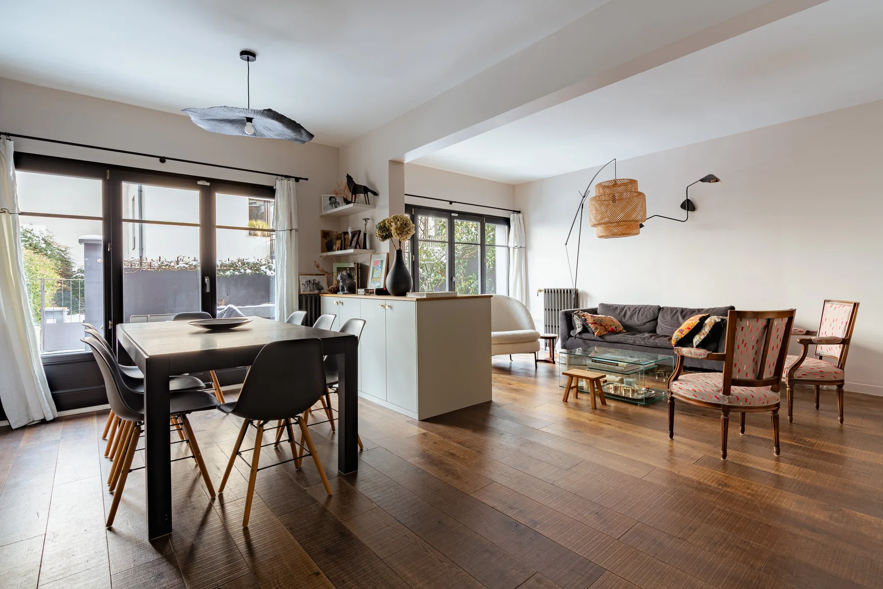 An open-plan dining and living area with a dining table and seating.
