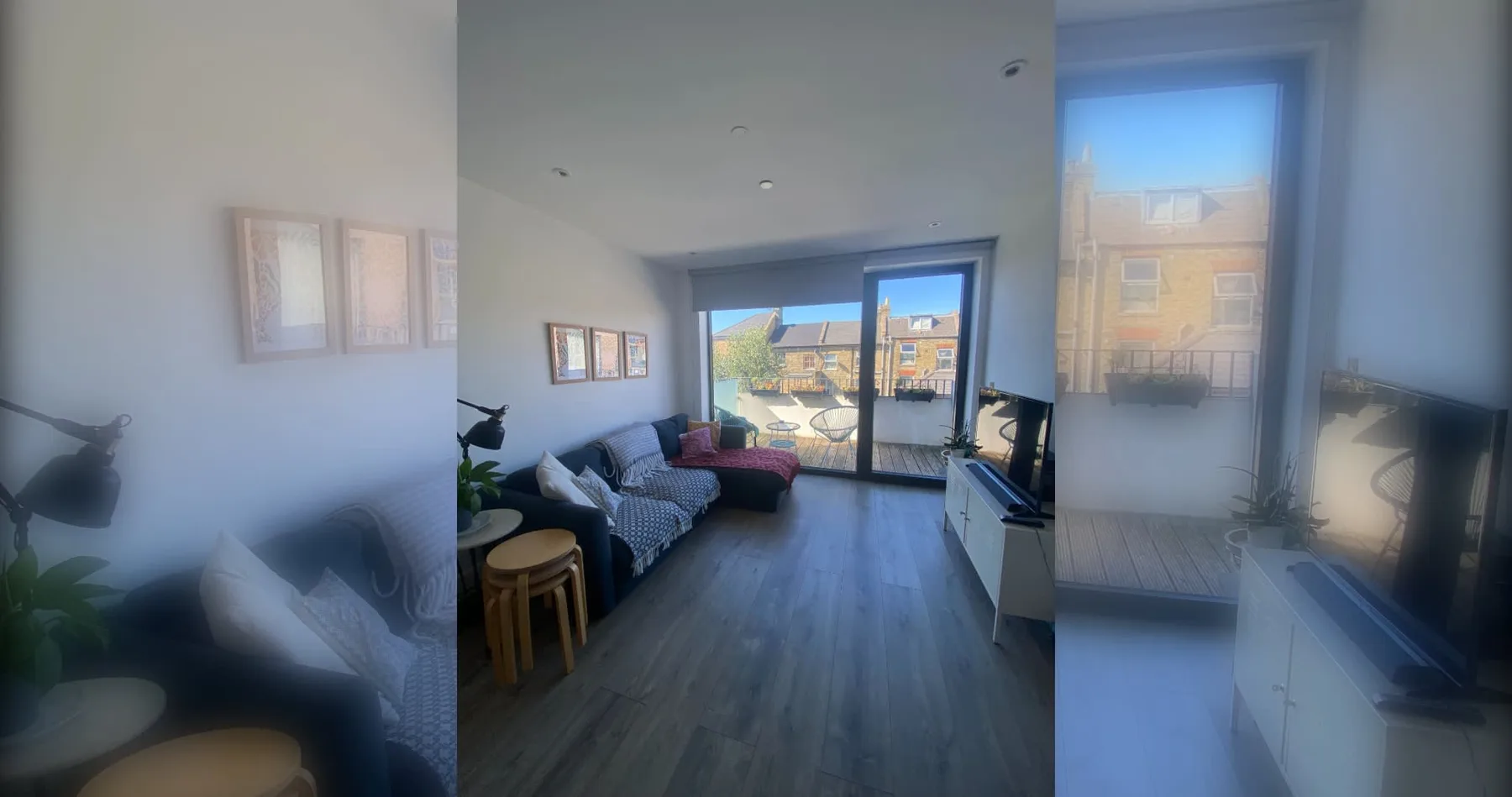 A living room with seating and large windows opening onto a balcony.