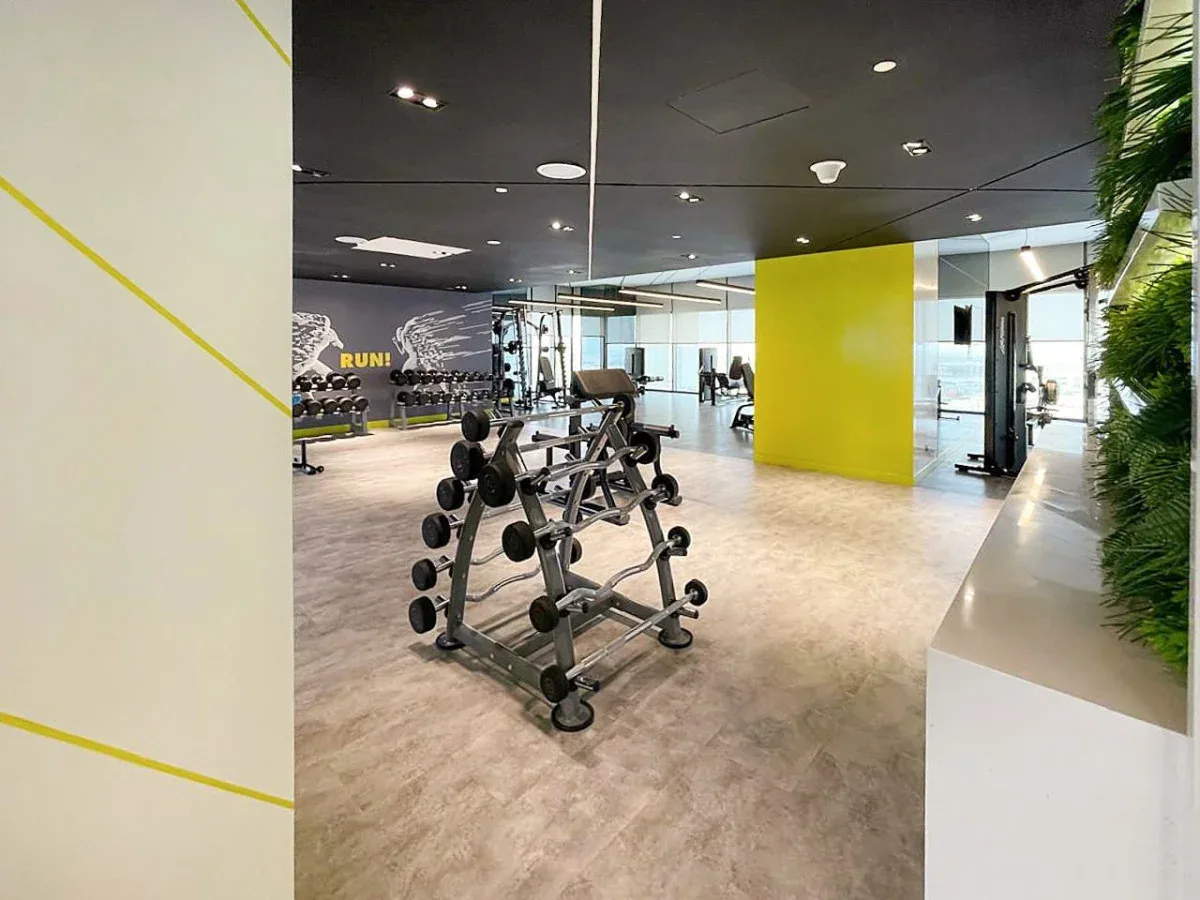 A fitness room with weight-training equipment and exercise machines.