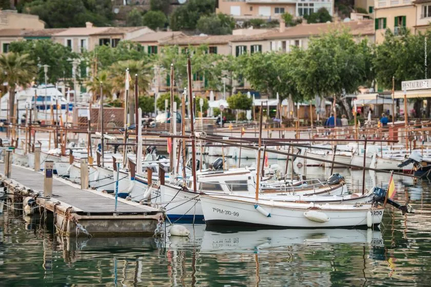A marina filled with small boats moored along wooden docks.