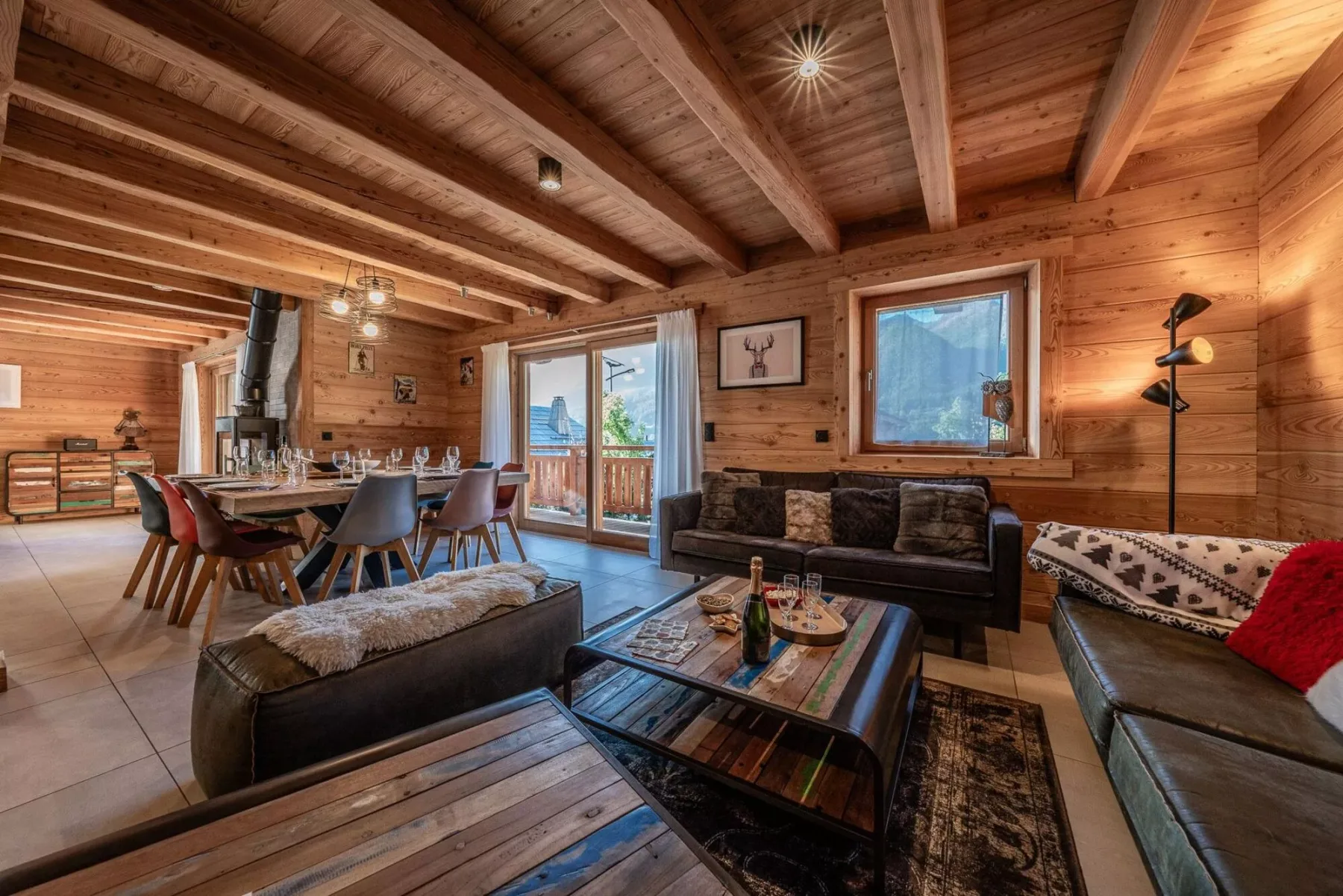 A wood-paneled living and dining area with seating around a coffee table.