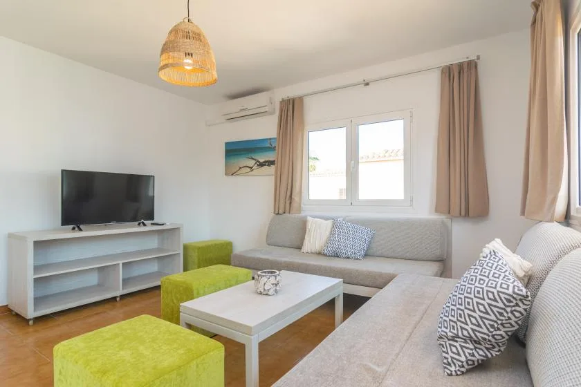 Living room with seating, a television, and a coffee table.
