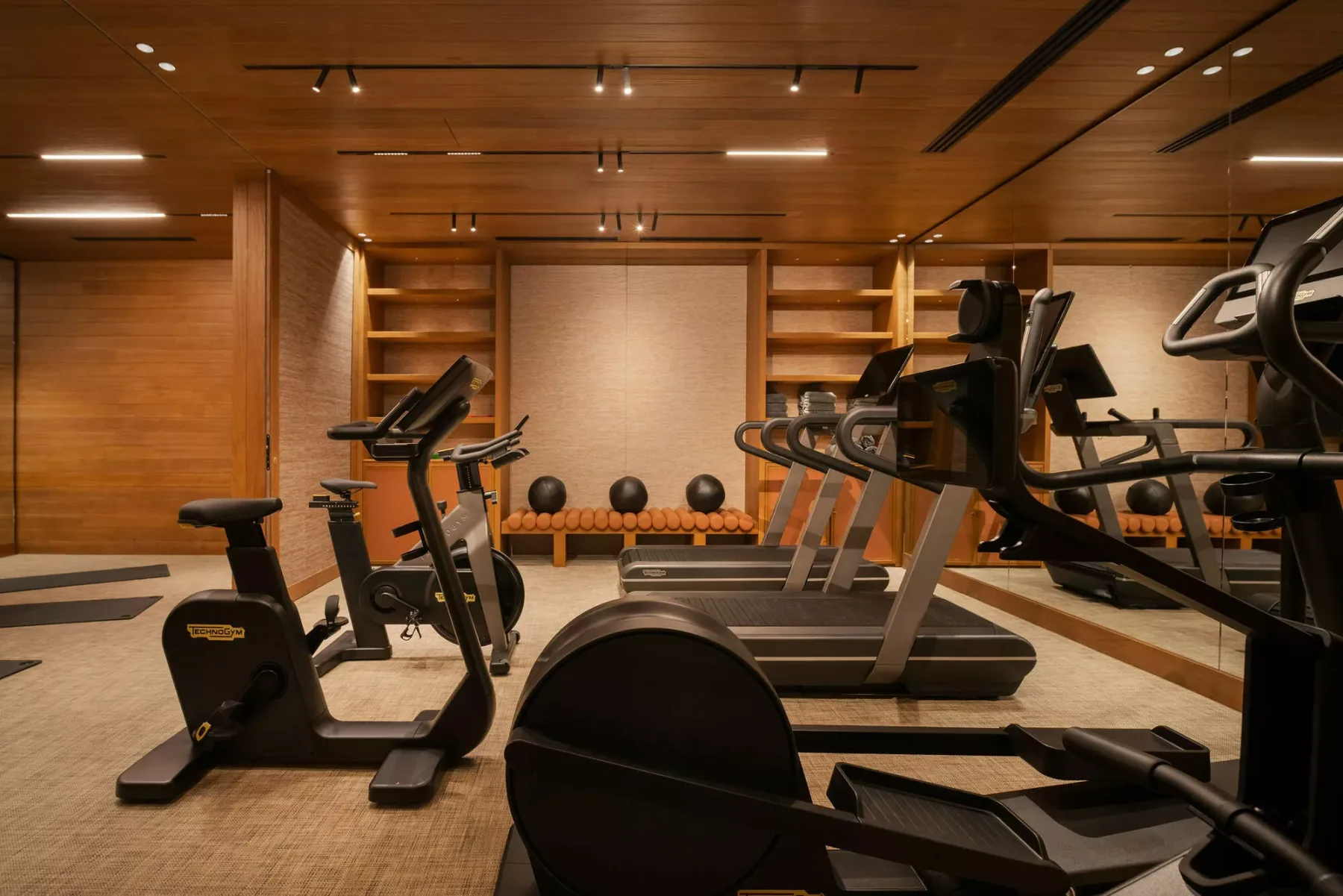 A gym with exercise bikes, treadmills, and weights.