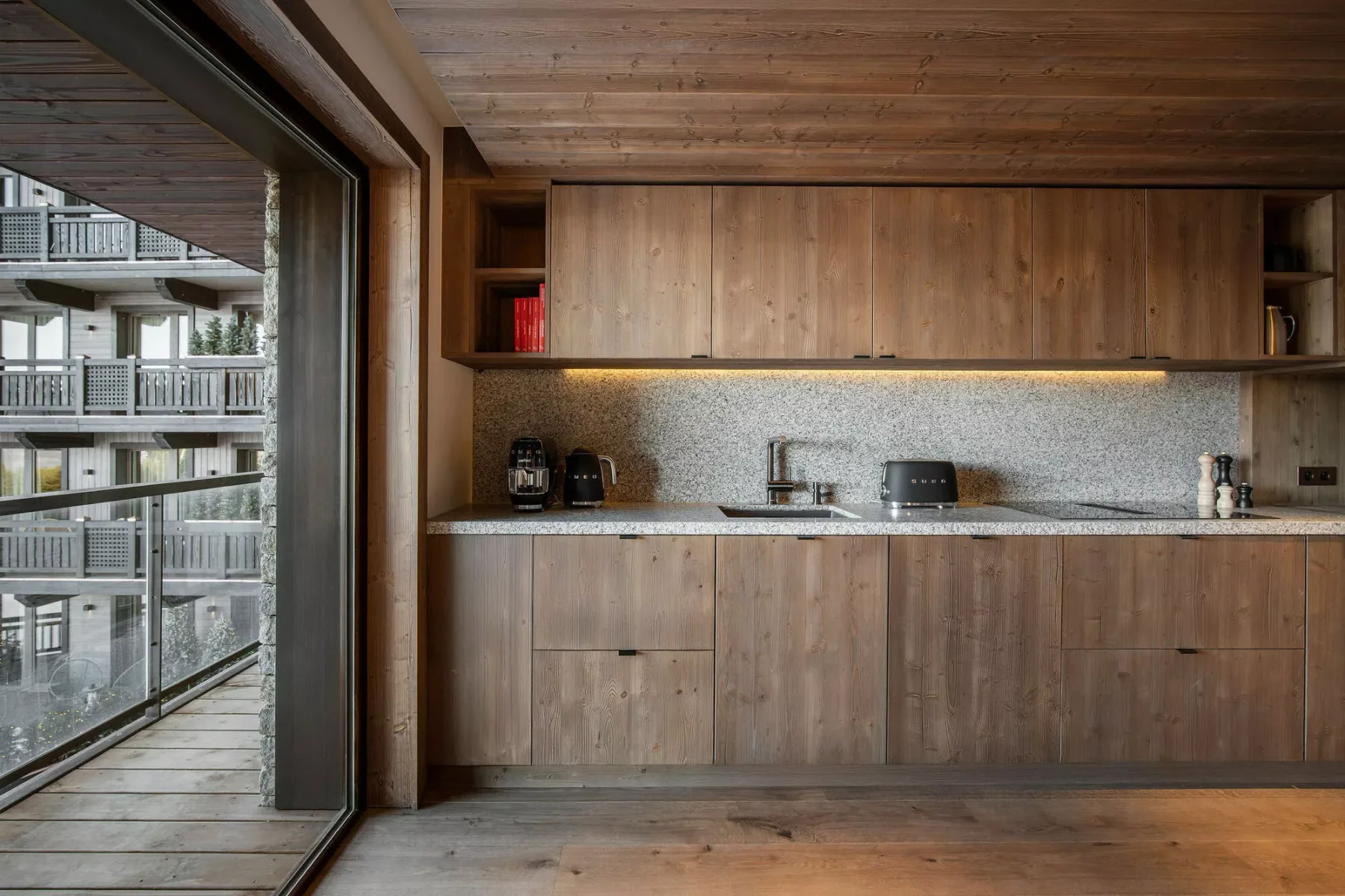 A wood-paneled kitchen with a countertop and small appliances.