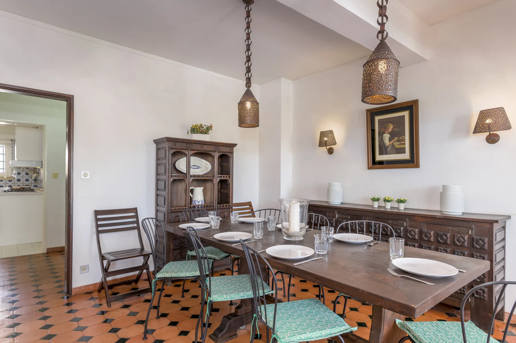 Dining room with a long wooden table and chairs.