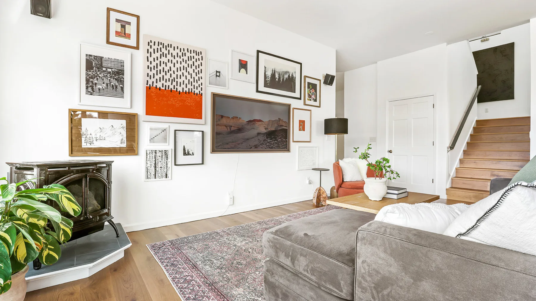 Living room with seating, a fireplace, and framed artwork on the walls.