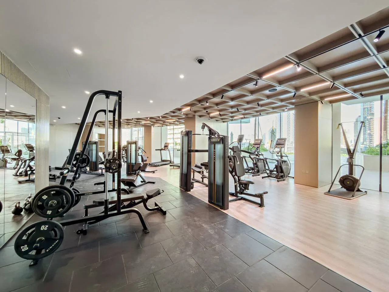 Un gimnasio amplio con máquinas de pesas, bancos y equipo de ejercicio.