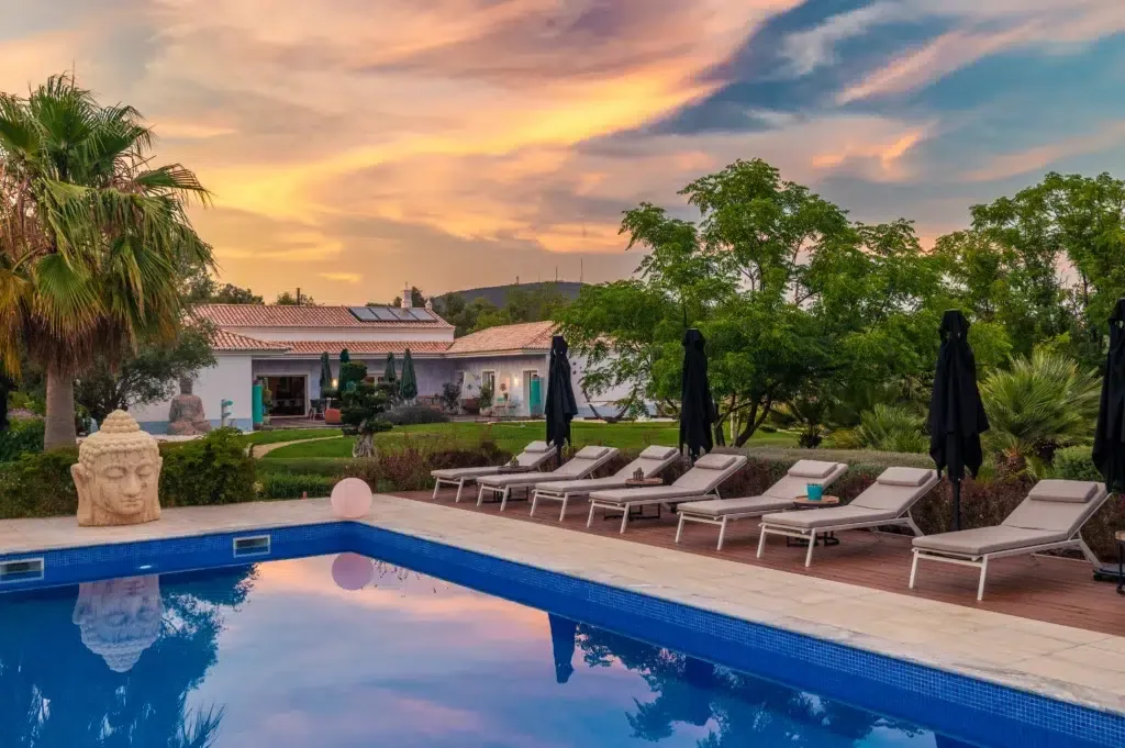 Outdoor swimming pool at sunset.