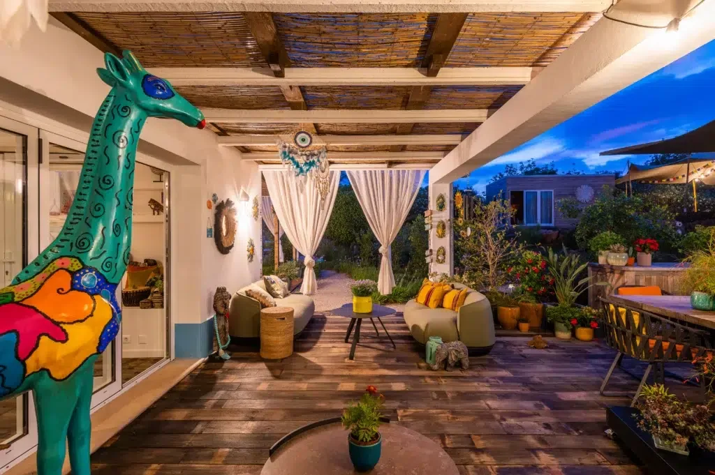 Covered outdoor patio and seating in the evening.
