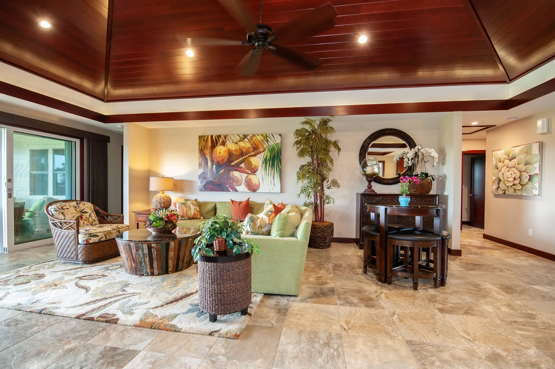 A bright living room with seating, a low table, and a dining area.