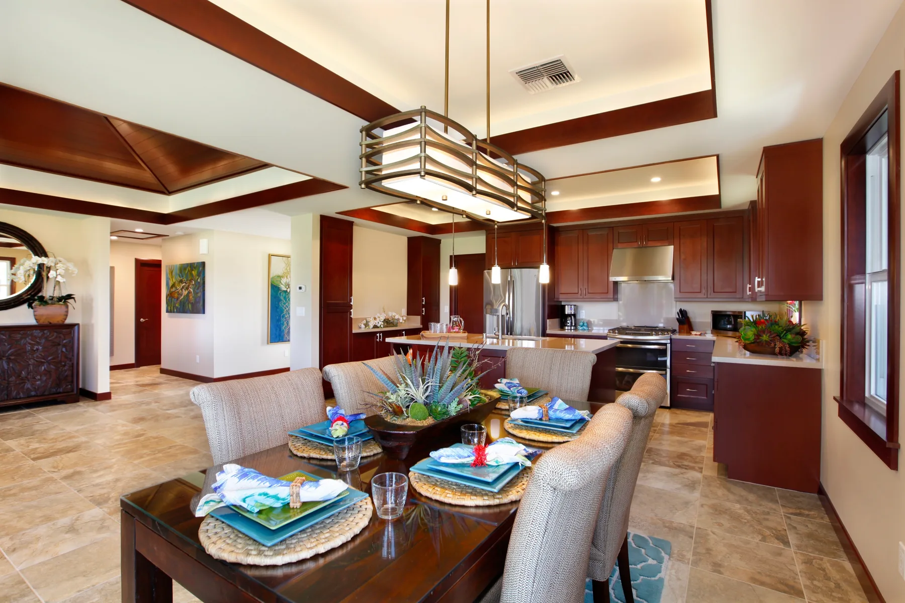An open-plan dining area and kitchen with a table set for a meal.