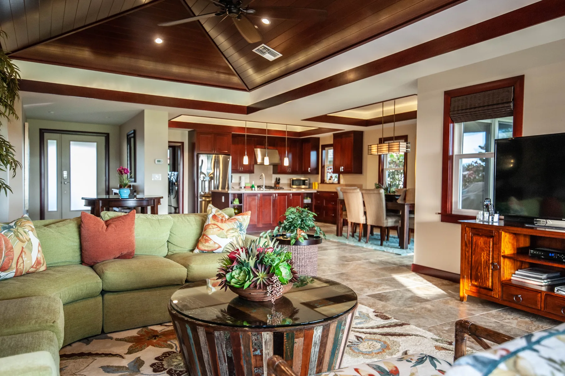 Open-plan living room with a seating area, dining table, and kitchen.