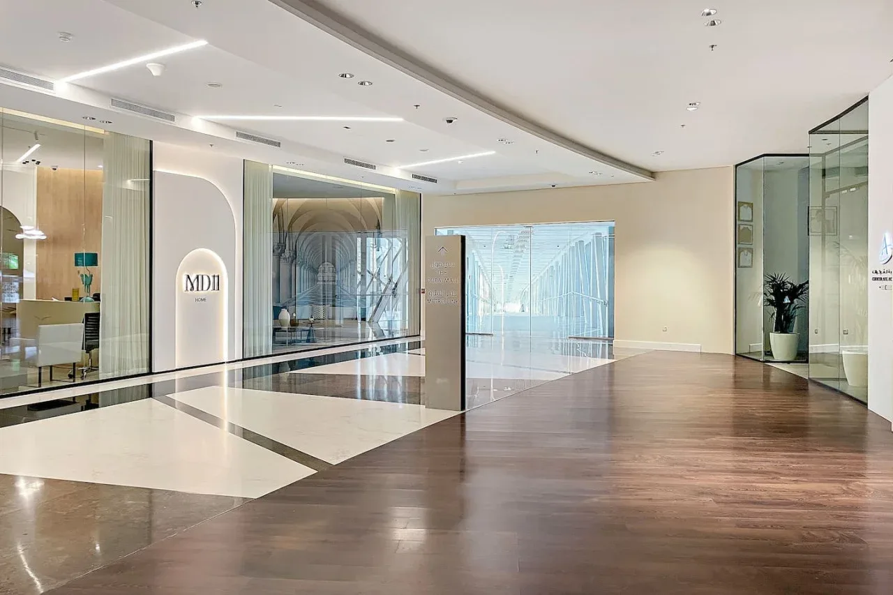 A spacious lobby with glass walls and a polished floor.