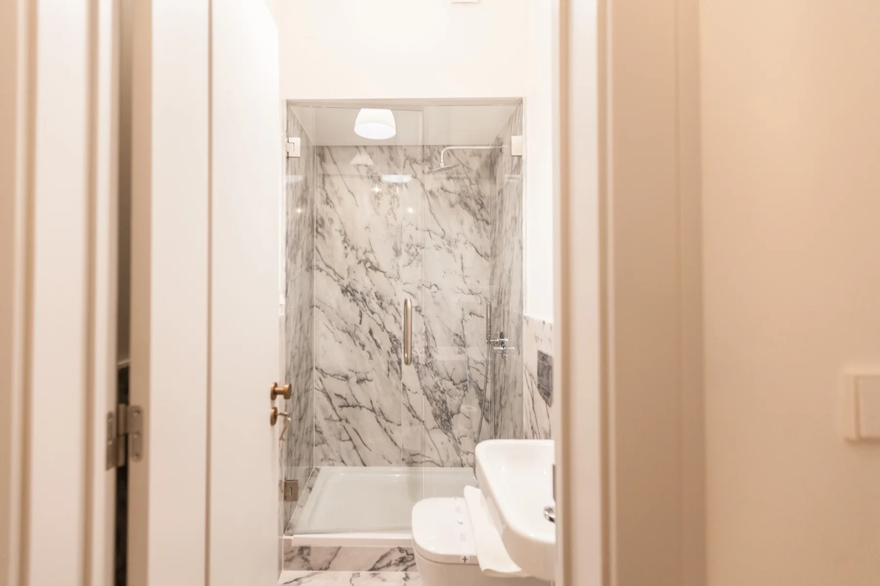 A bathroom with a shower and sink.