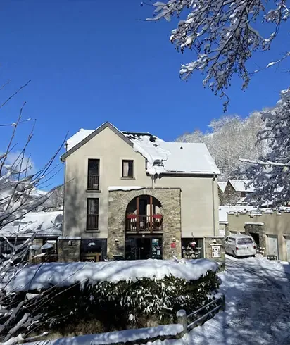 Stone building of the Auberge de Germ in winter
