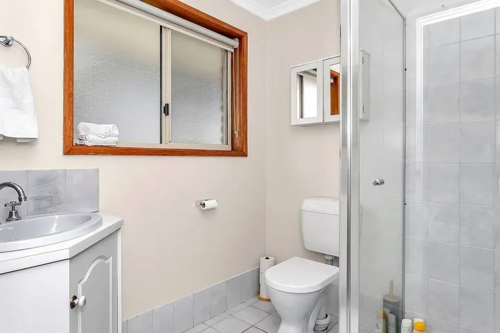 Un baño con lavabo, inodoro y ducha de vidrio.