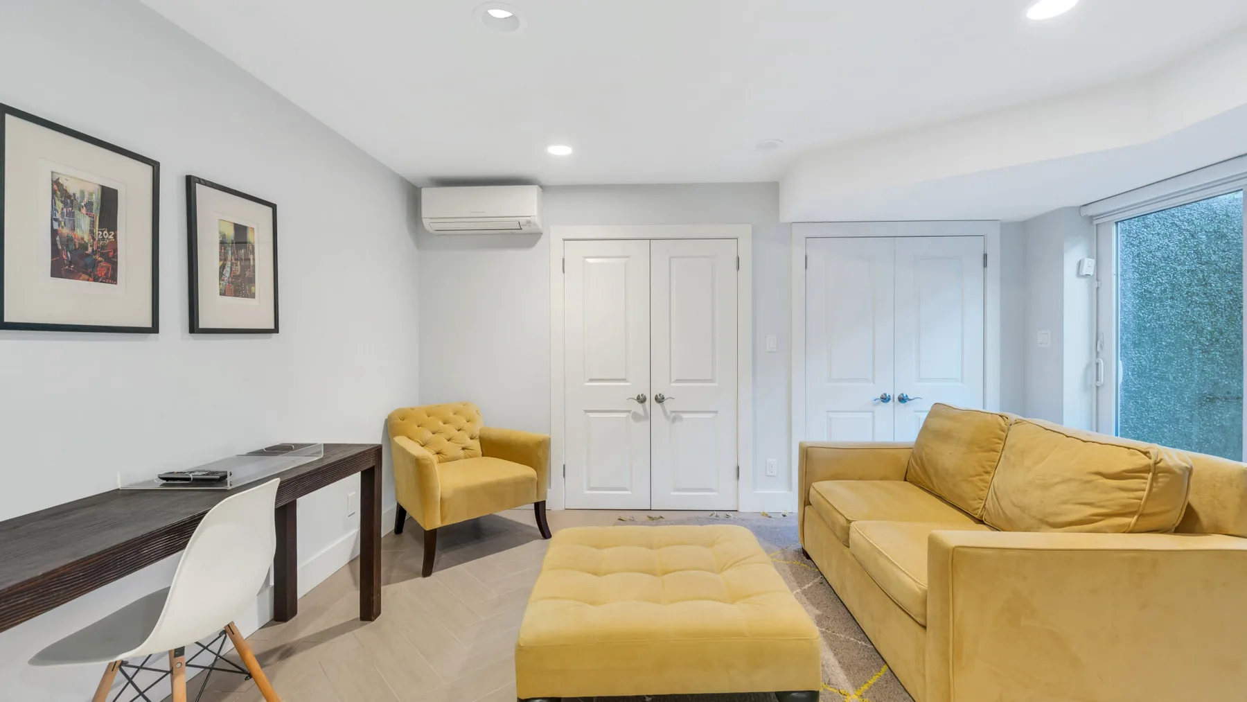 Una sala luminosa con asientos amarillos y un escritorio junto a la pared.