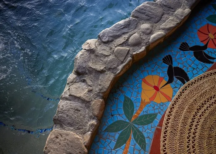 Colorful mosaic detail beside a pool