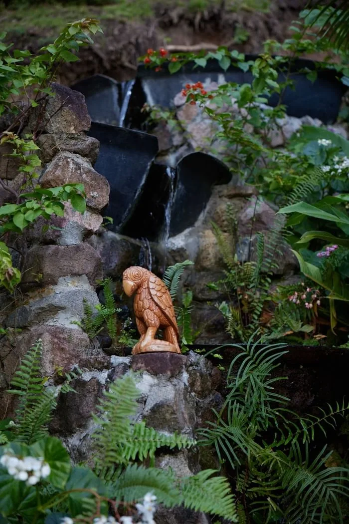Wooden sculpture beside a water feature