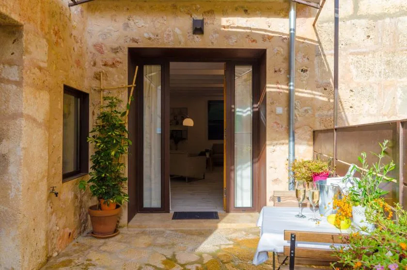 A stone patio with an open doorway leading into an interior room.