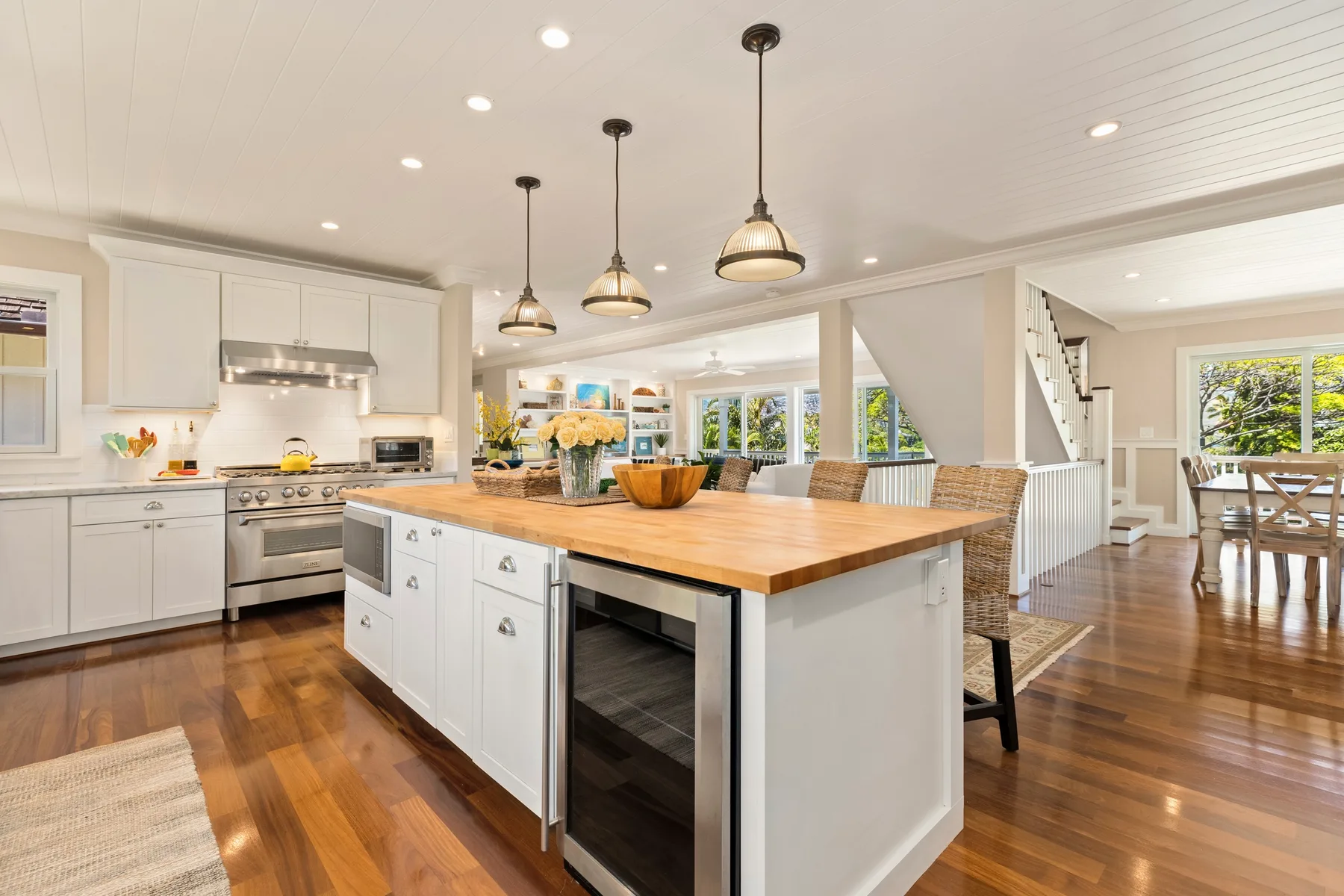 A bright open-plan kitchen with a large island and dining area.