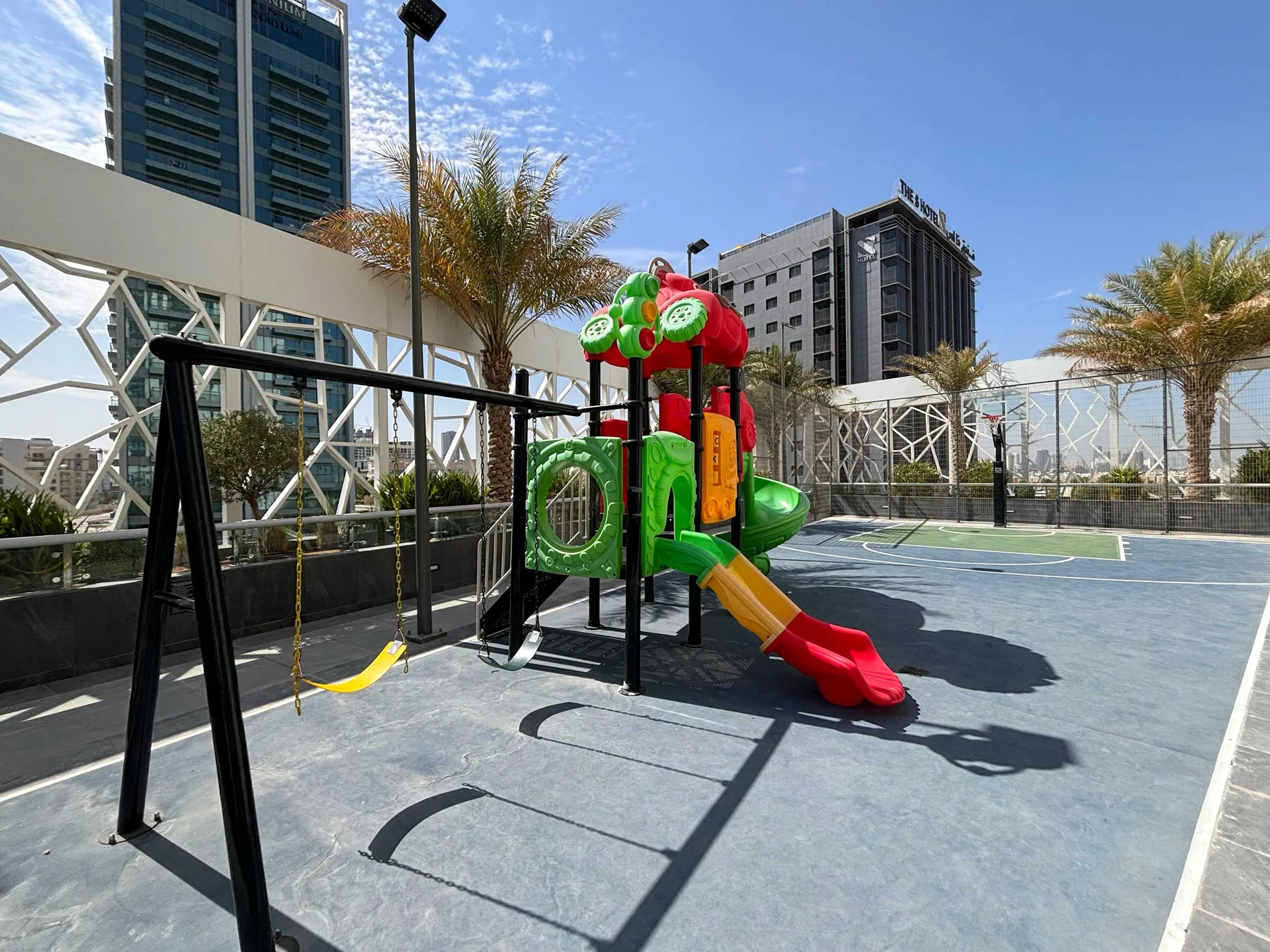 An outdoor playground with colorful climbing equipment and a slide.