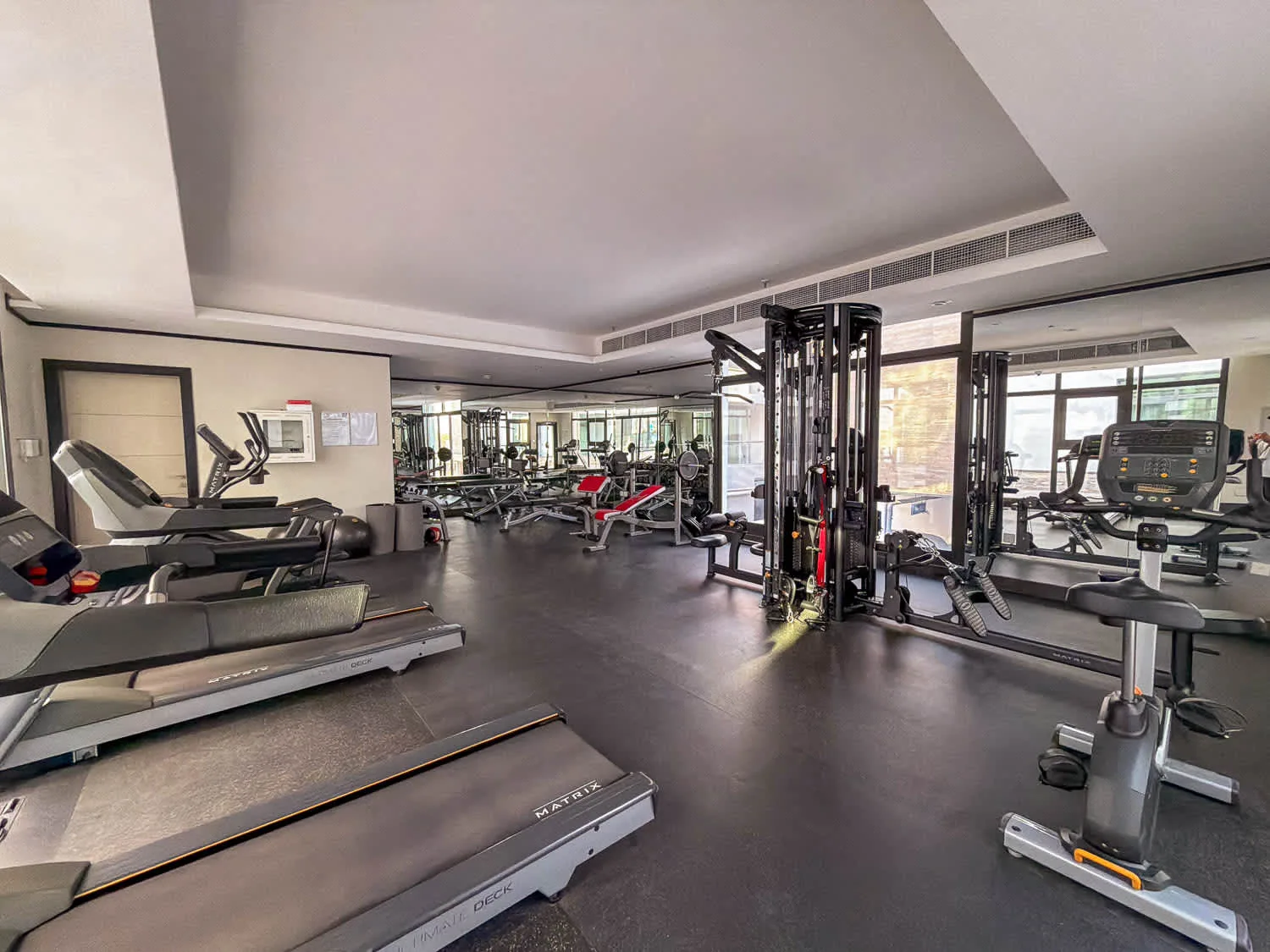 A gym with treadmills, weight machines, and exercise bikes.