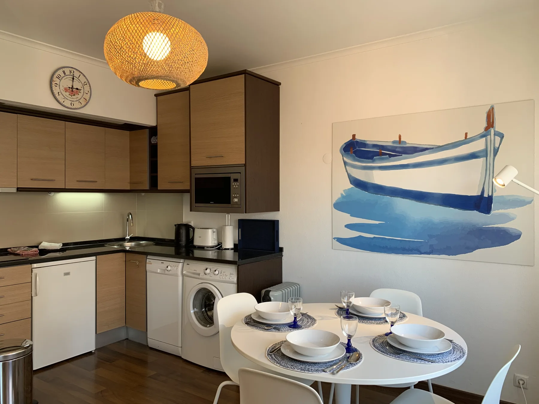 A compact kitchen and dining area with a table set beside the cabinets.