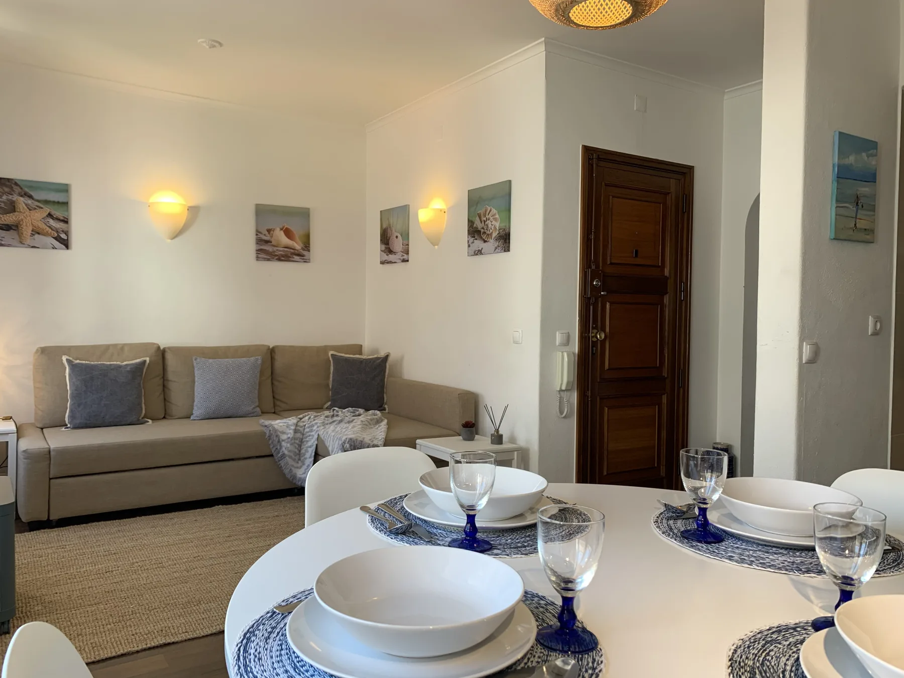A living and dining area with a set table and seating.