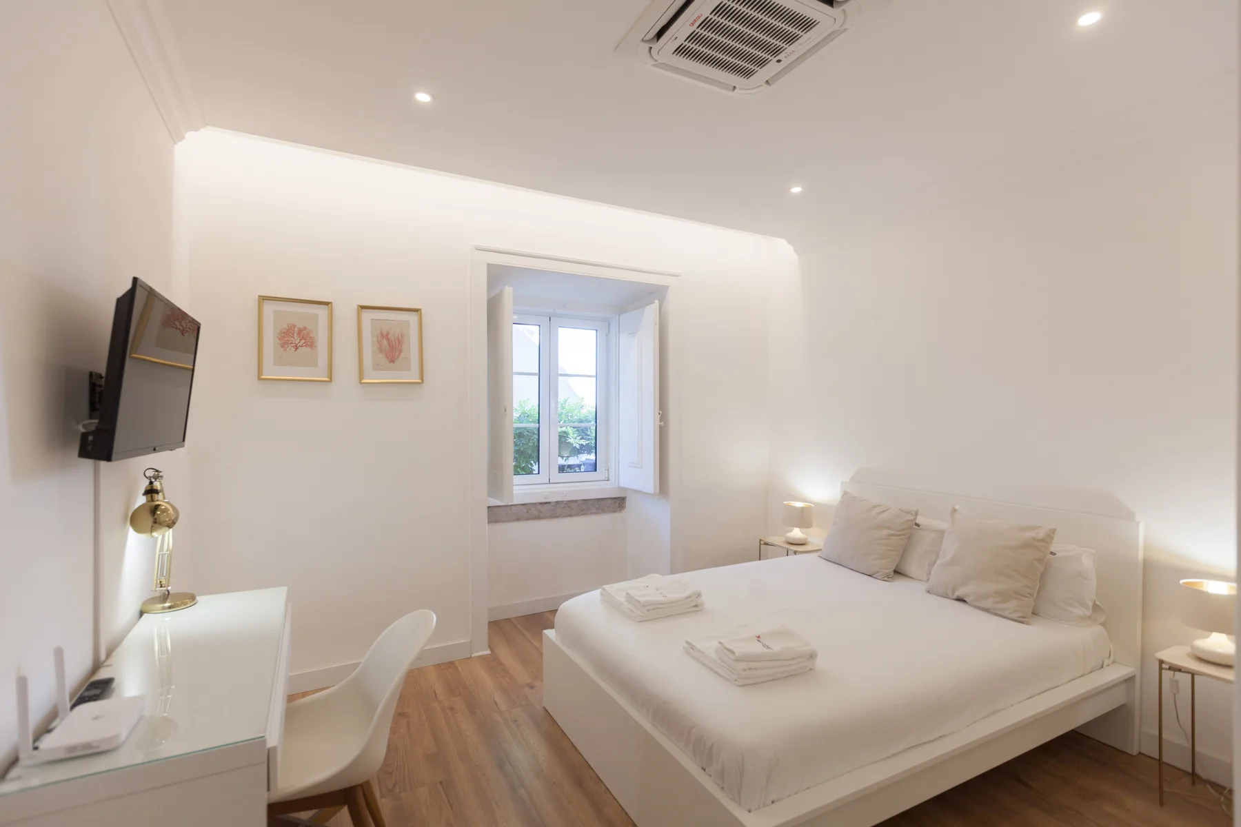 A bright bedroom with a bed and a window.