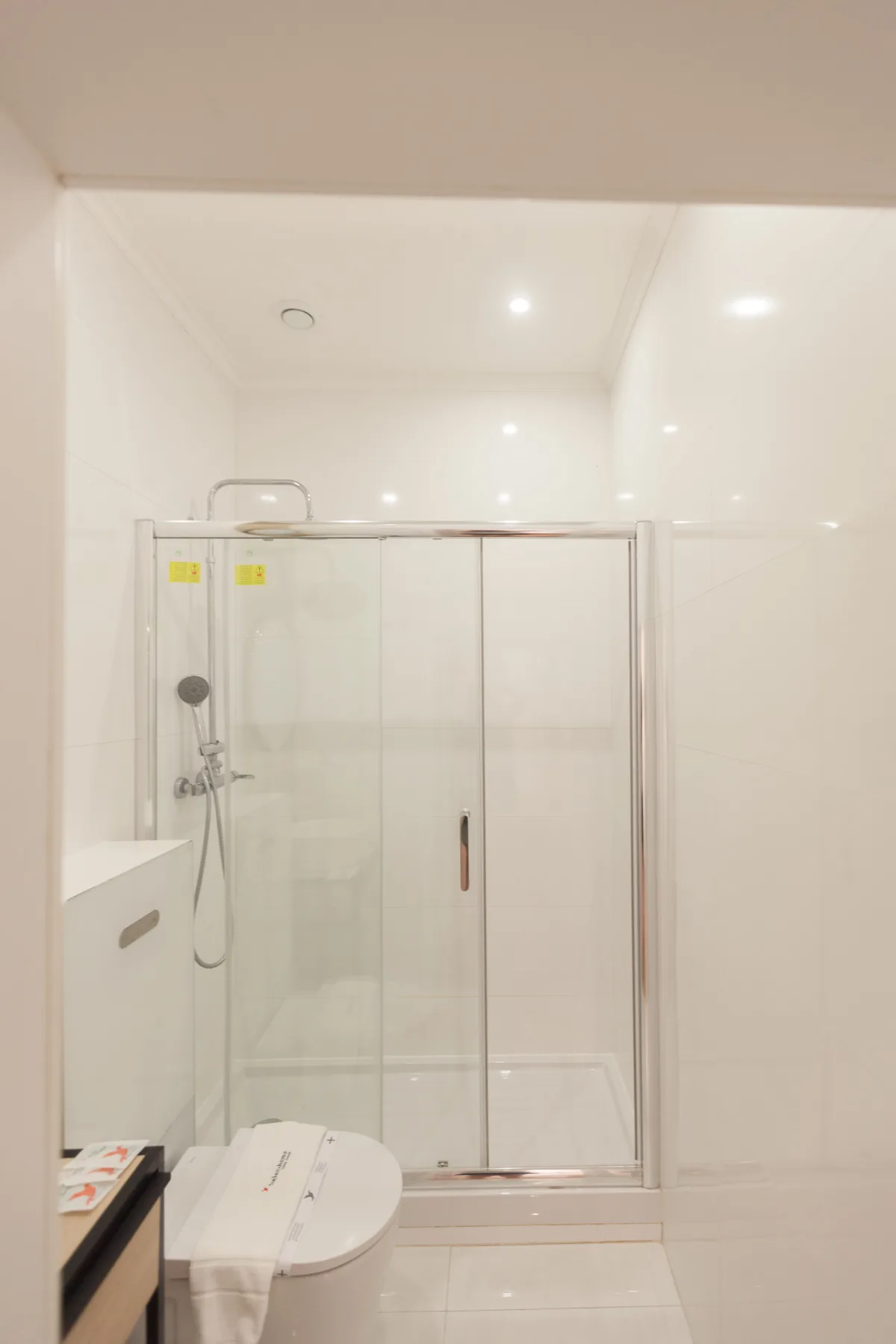 A bright bathroom with a shower and toilet.