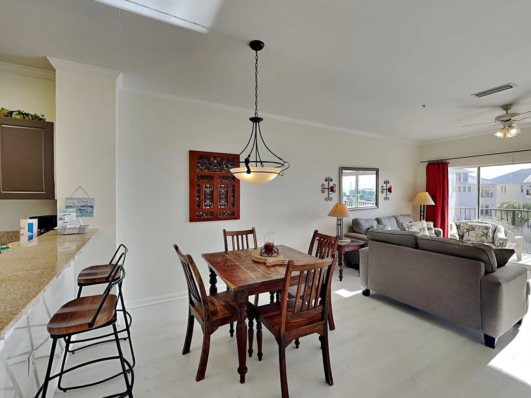 An open-plan living and dining room with a wooden dining table and seating.