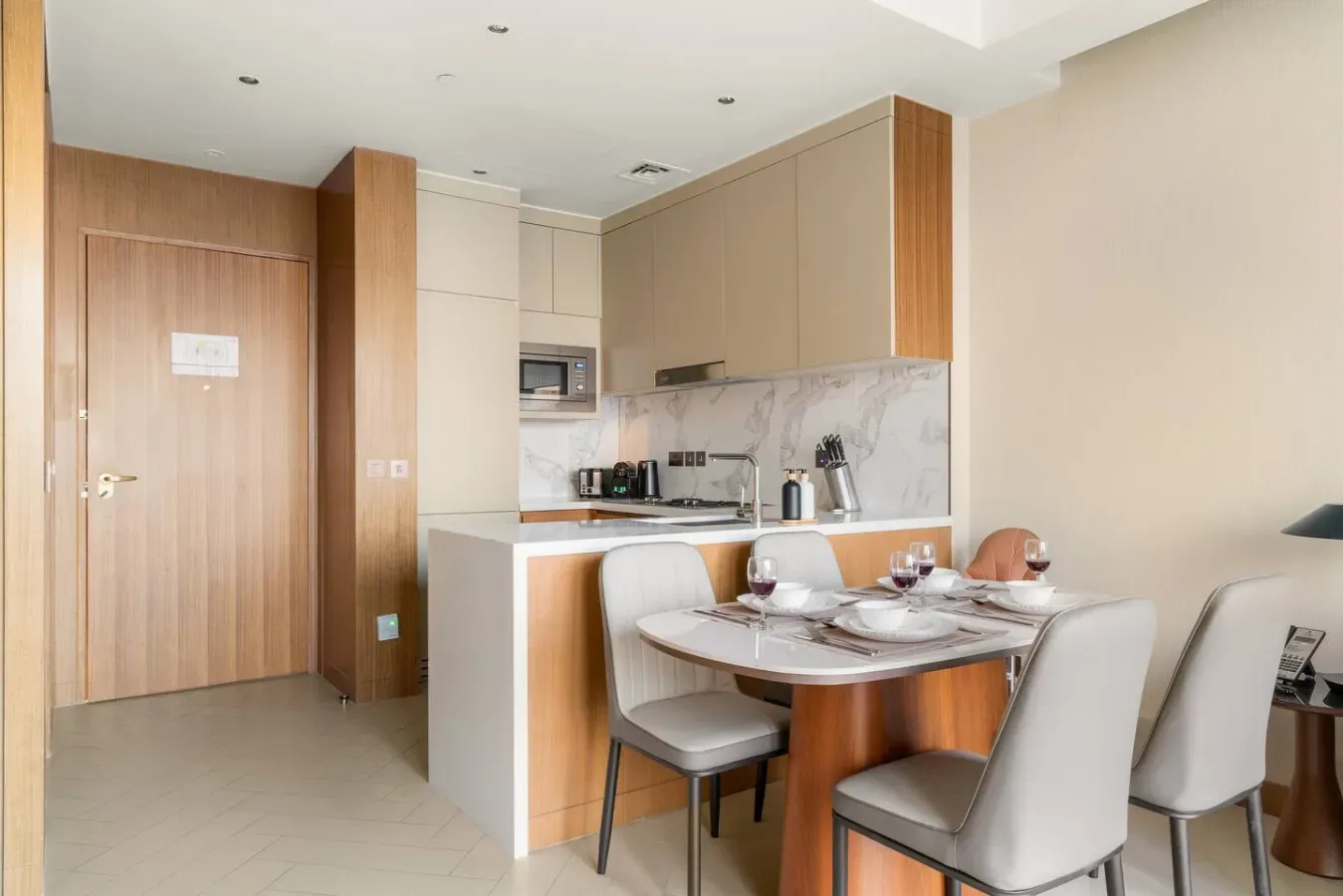 A modern kitchen and dining area with a table set beside the counter.