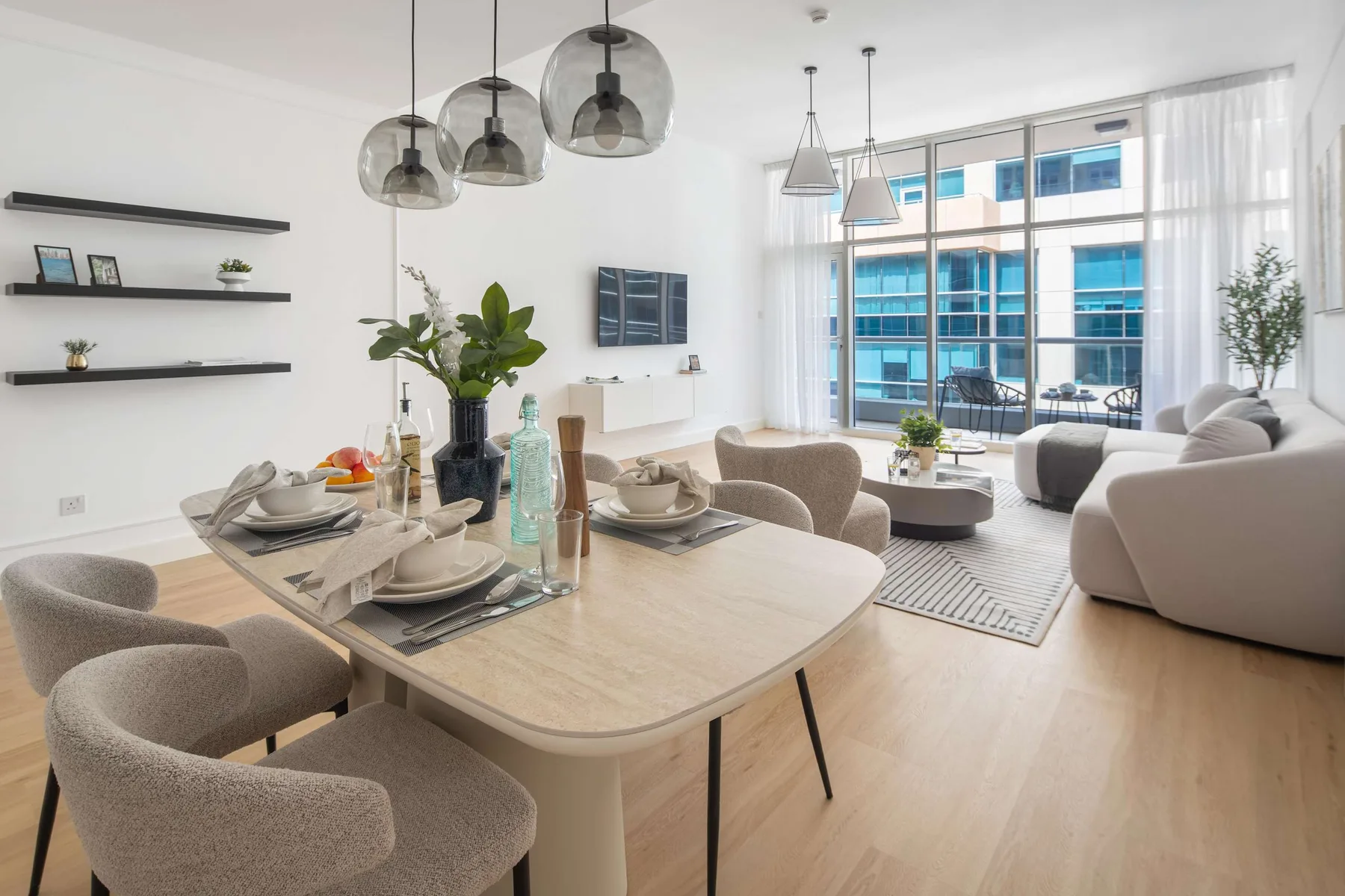 A bright open-plan living and dining area with a large table and seating.