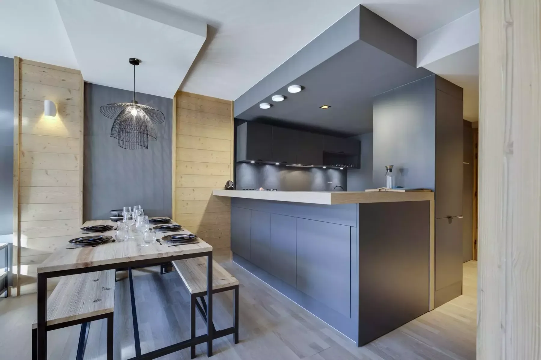 A modern kitchen with a dining table set beside the counter.